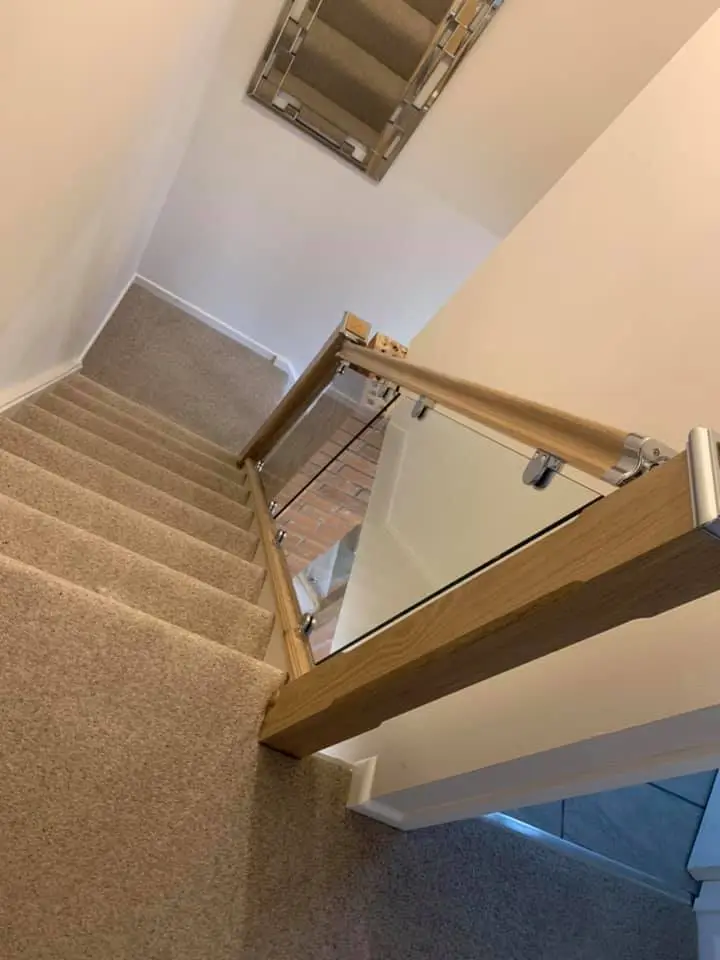 wooden bannister holding glass panels