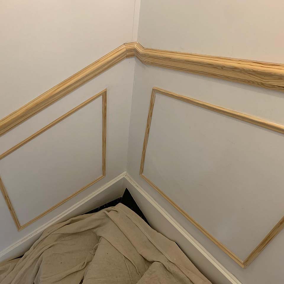 unfinished wooden paneling on a staircase