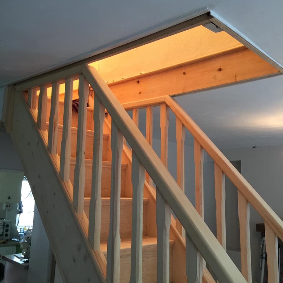 wooden staircase leading up to the ceiling